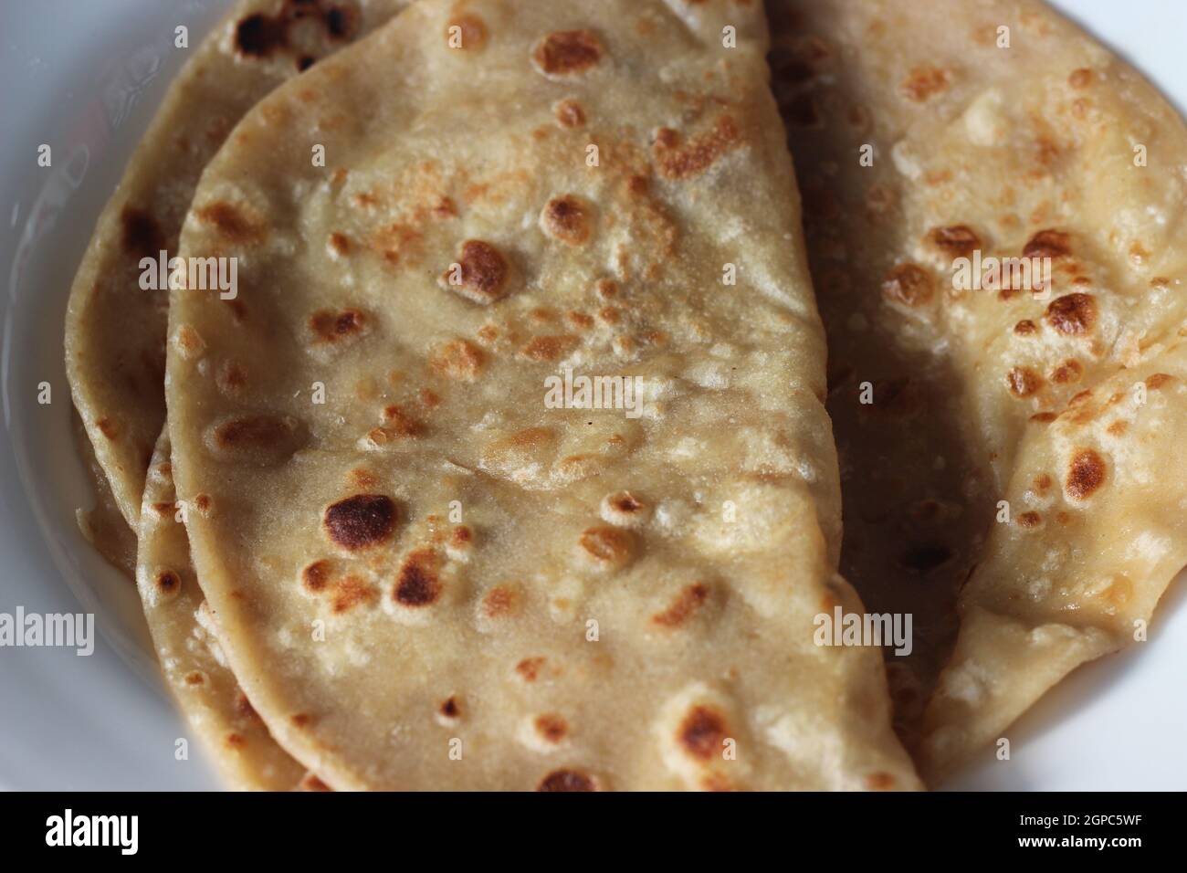 Closeup view of hand made plain bread in oil called paratha roti. Paratha is popular in India