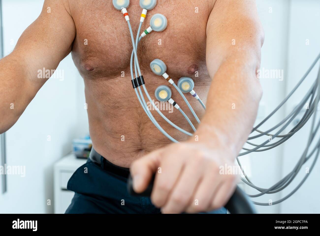 Patient on exercise bike with electrodes during stress ECG Stock Photo