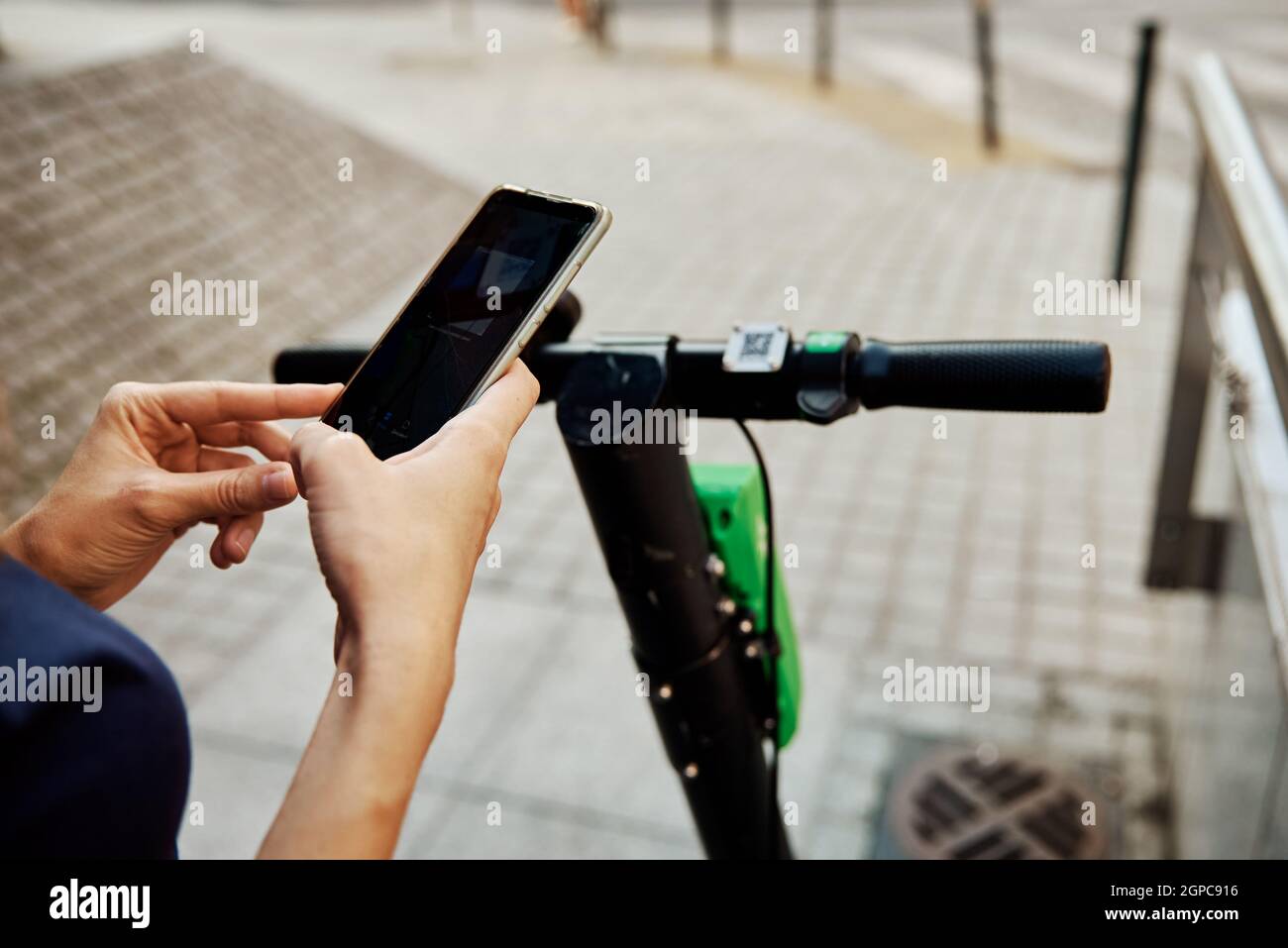 Woman unlock electric scooter for rent using mobile phone app. Modern urban  eco transport Stock Photo - Alamy