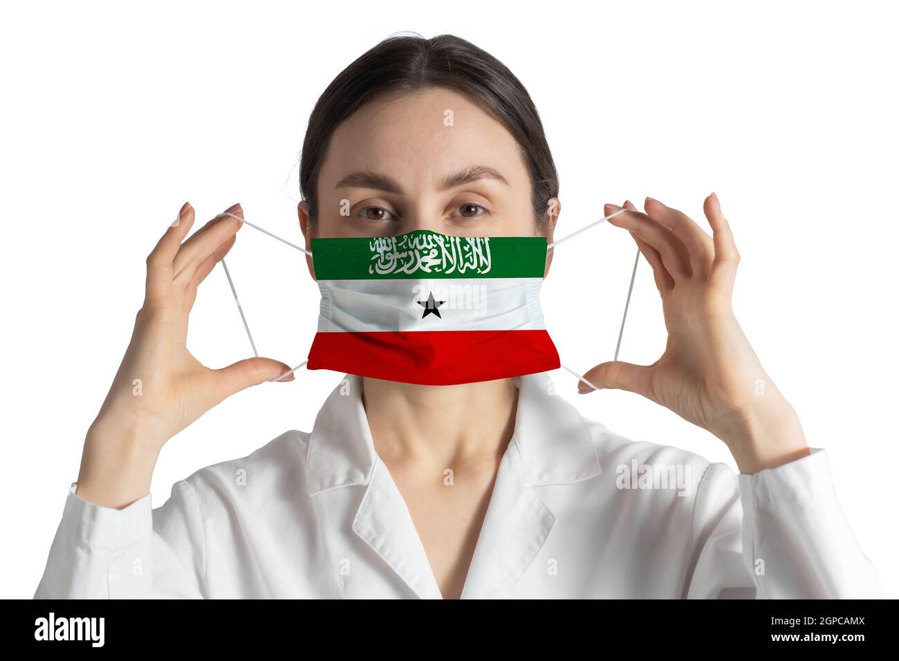Respirator with flag of Somaliland Doctor puts on medical face mask isolated on white background. Stock Photo