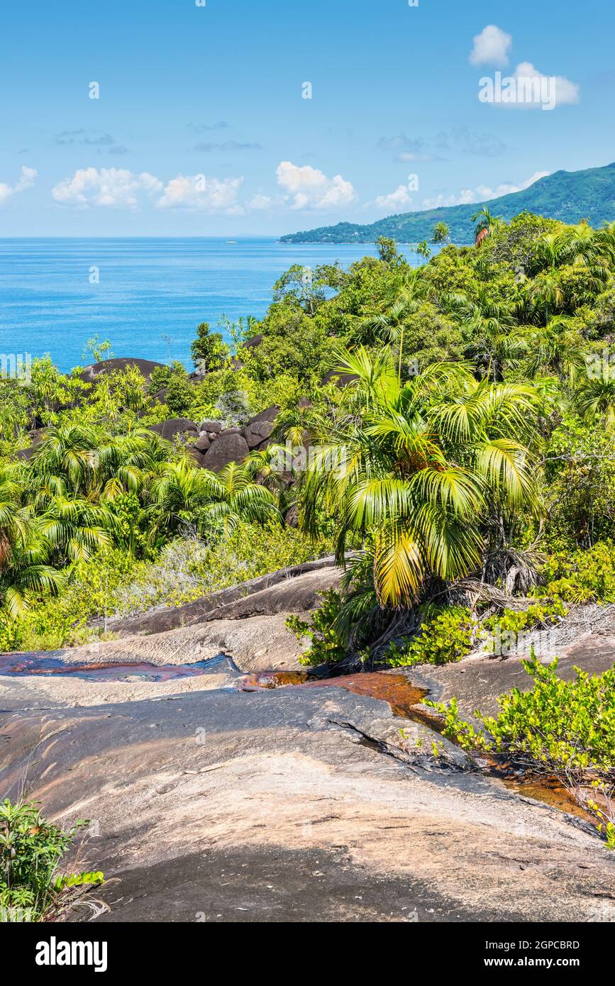 View from Anse Major Nature Trail over the northwest coastline of Mahe island and granite rock in the foreground, Seychelles, Indian Ocean, Eastern Af Stock Photo