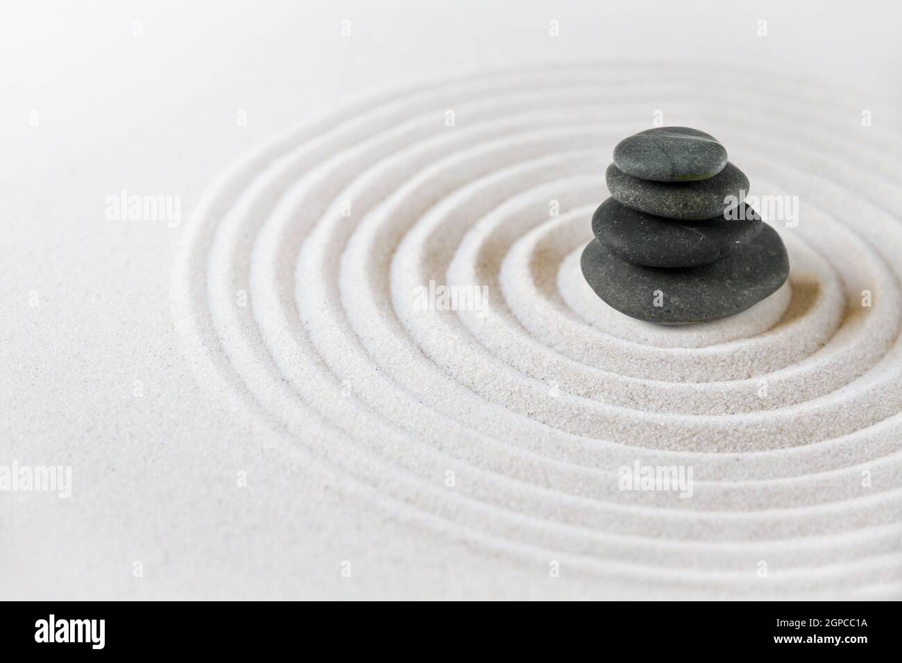 Black stones pile in the sand. Zen japanese garden background scene ...