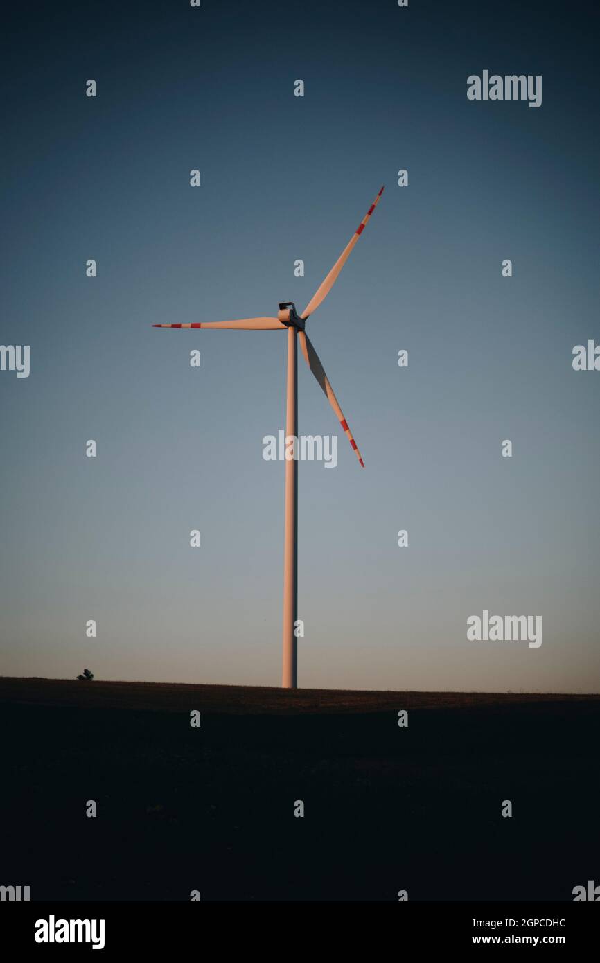 silhouette landscape with single wind turbine during sunset Stock Photo ...