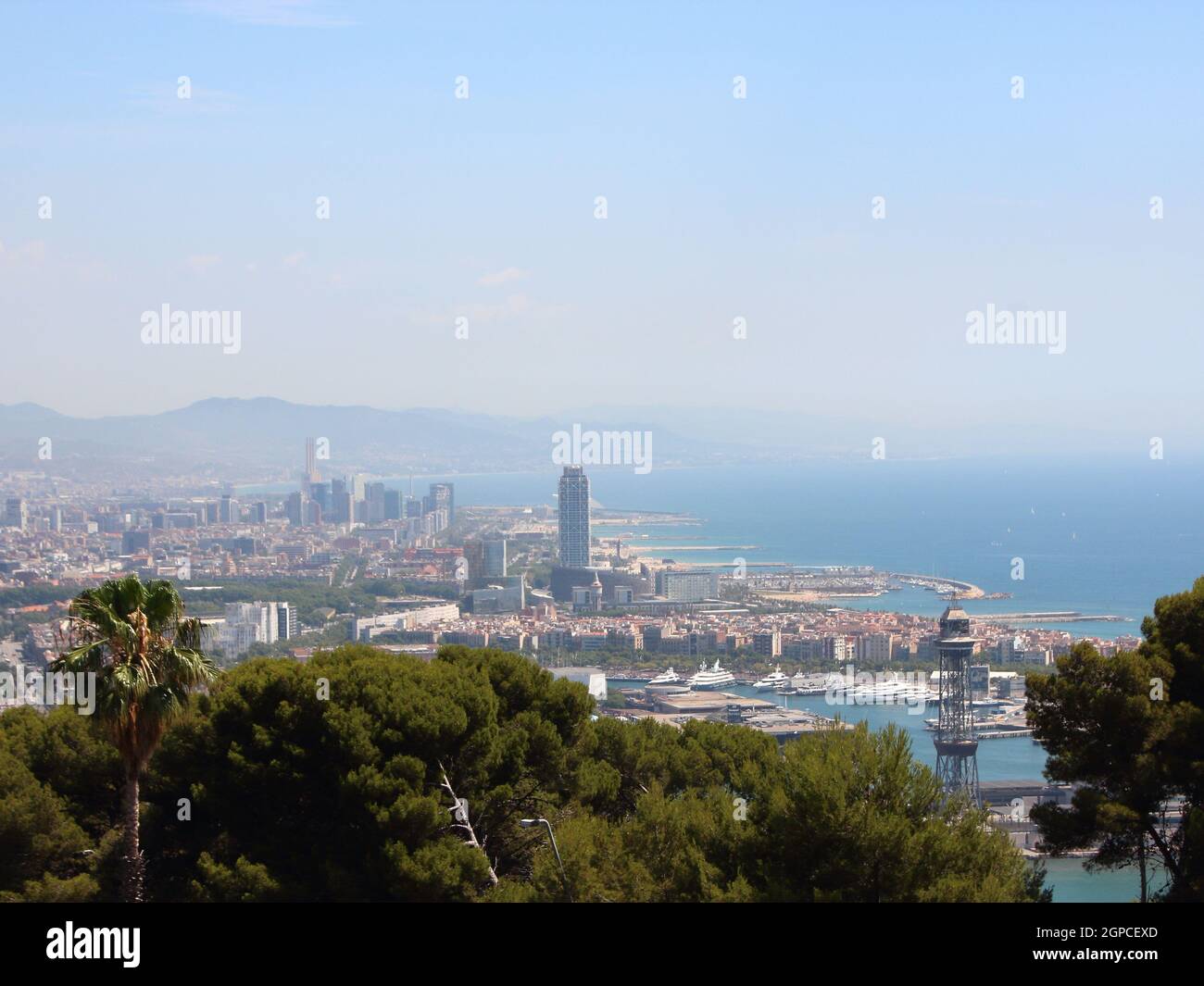 Horizon over Barcelona Spain with Harbor and Beach Background. Smog is hiding the mountains. Stock Photo