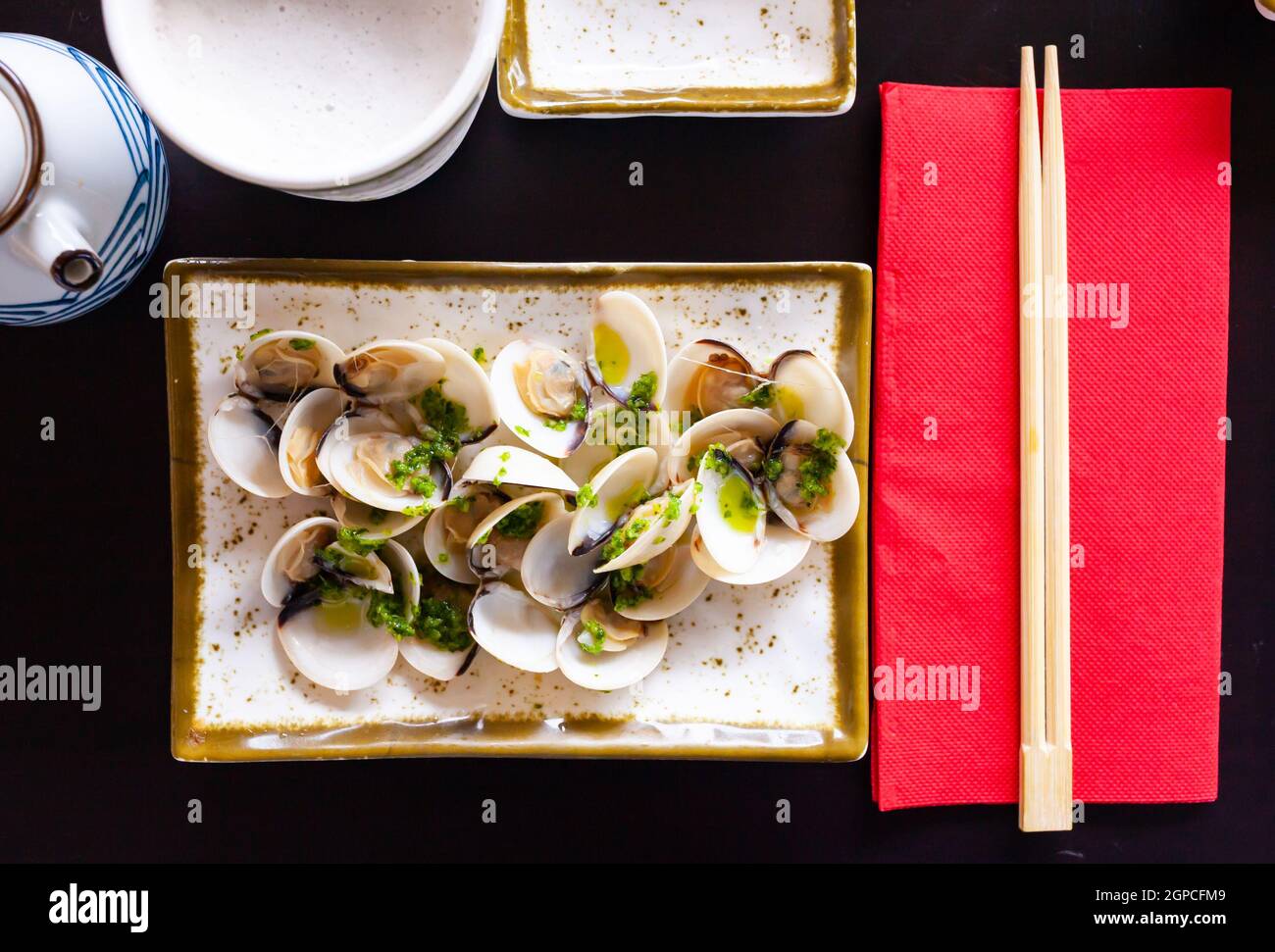 Japanese sake steamed clams with ginger and green onions Stock Photo