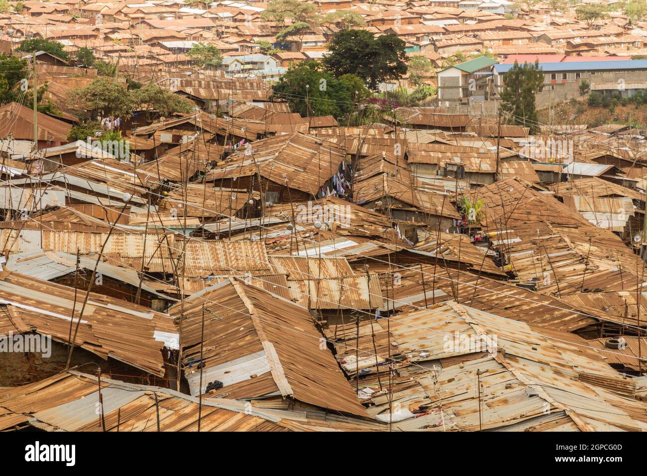 The brown and rusted roof tops of many buildings in the Kibera slum of Nairobi, Kenya. Stock Photo