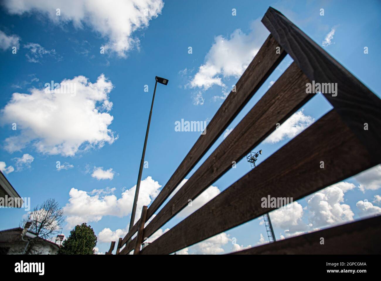 Detail of a fence and blue sky with clouds in spring Stock Photo - Alamy