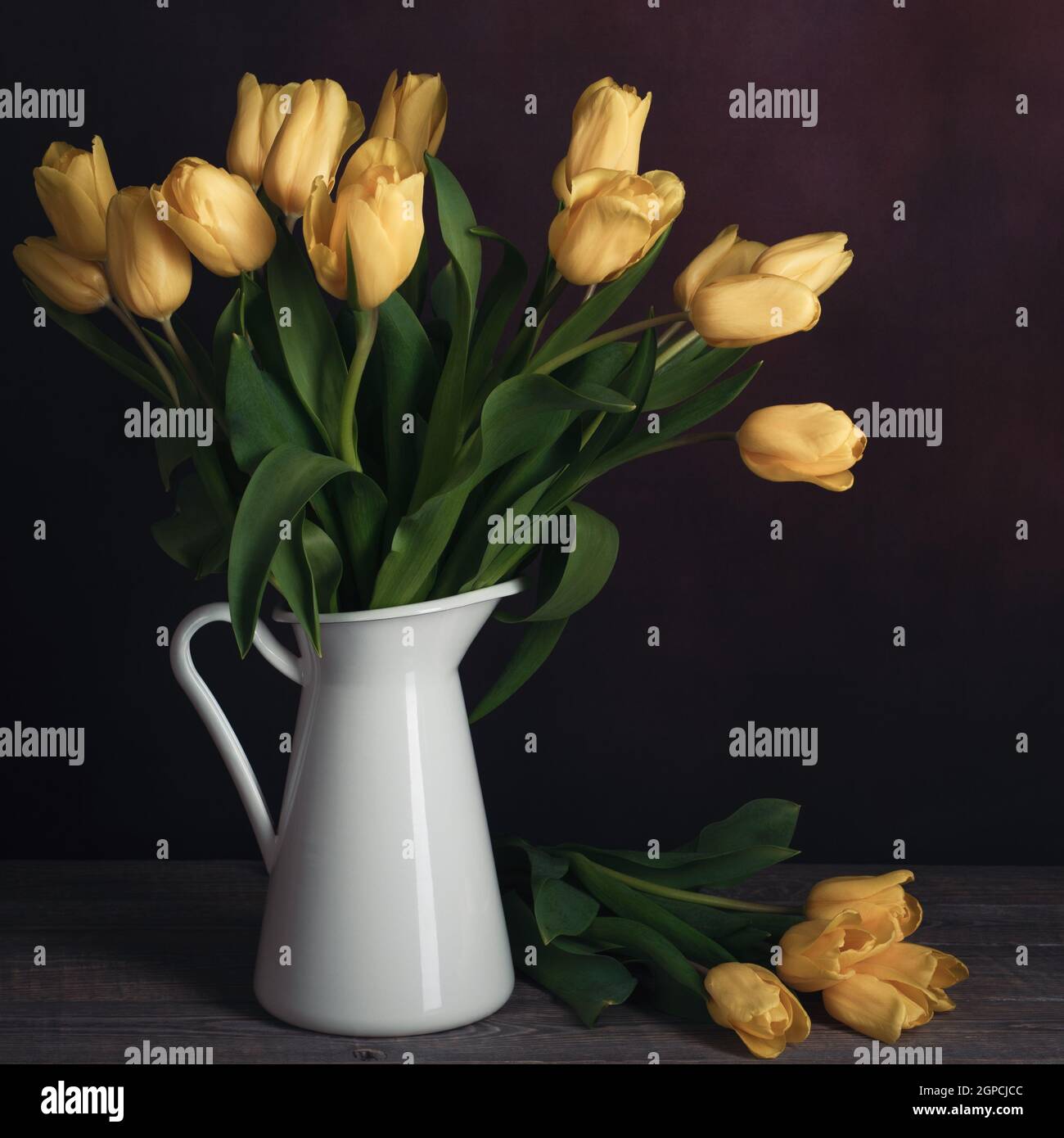 Tulips in a jug. Classic still life with a bouquet of yellow tulip ...