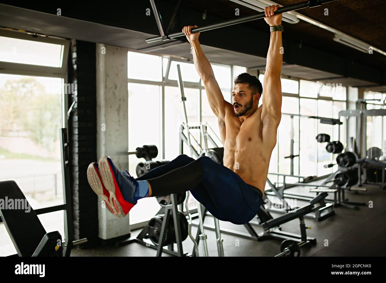 Young fit man exercising in a gym. Sport people healthy lifestyle ...