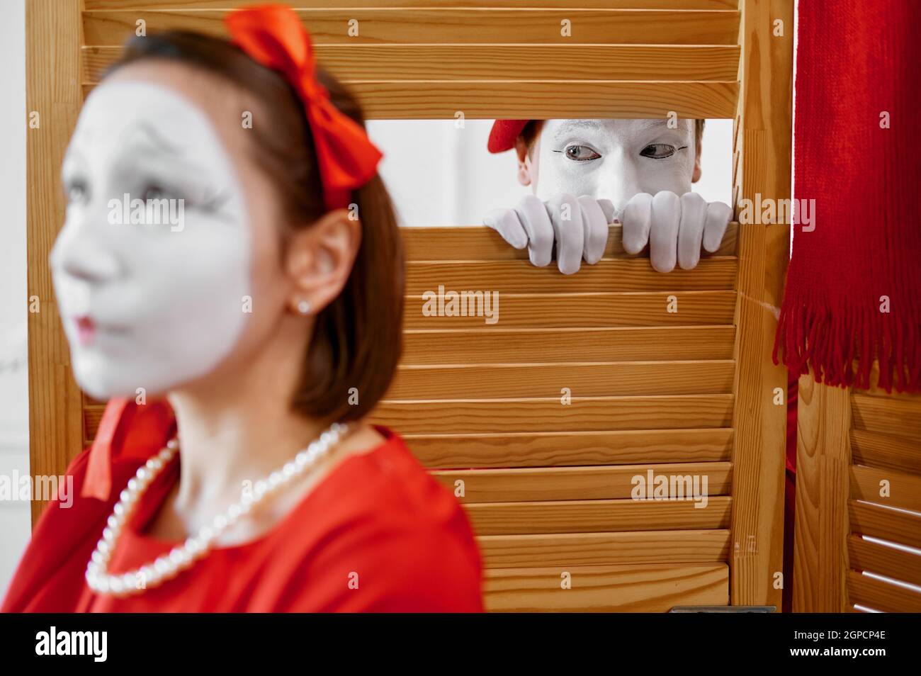 Two mime artists, comedy voyeurism scene. Pantomime theater, parody comedian, positive emotion, humour performance, funny face mimic and grimace Stock Photo