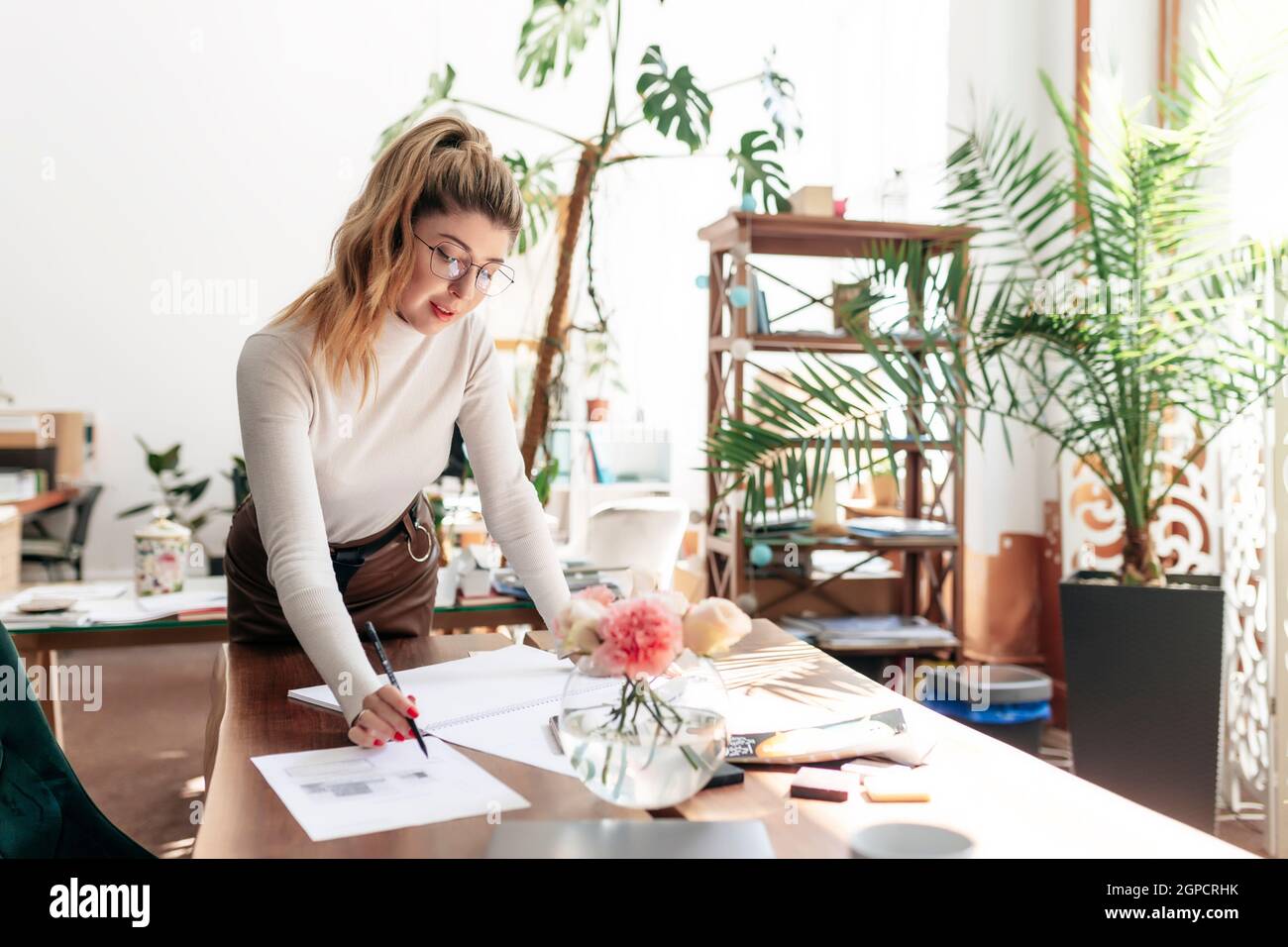 An interior designer is working on a new project. Creating a sketch ...
