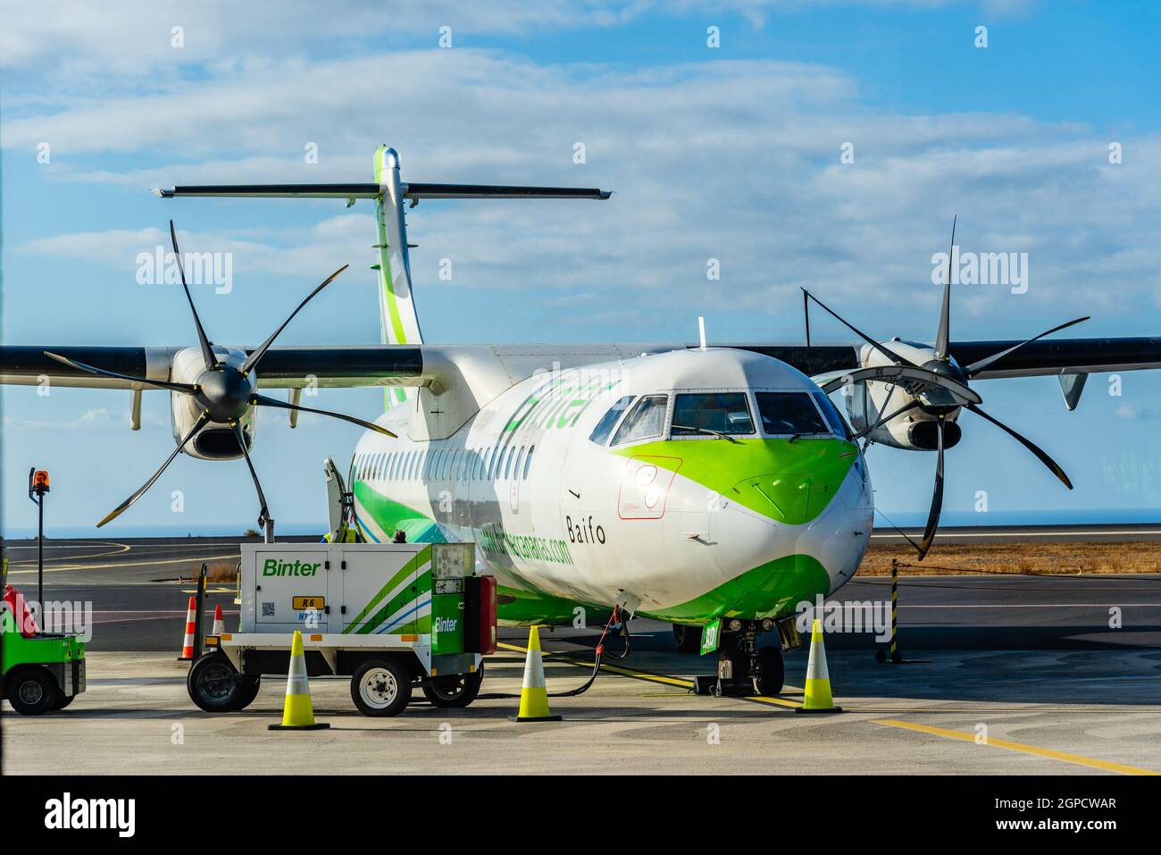 La Gomera, Spain - August 12, 2021: Propeller airplane provisioning on the runway. ATR 72 plane of Binter Canarias Airline Stock Photo