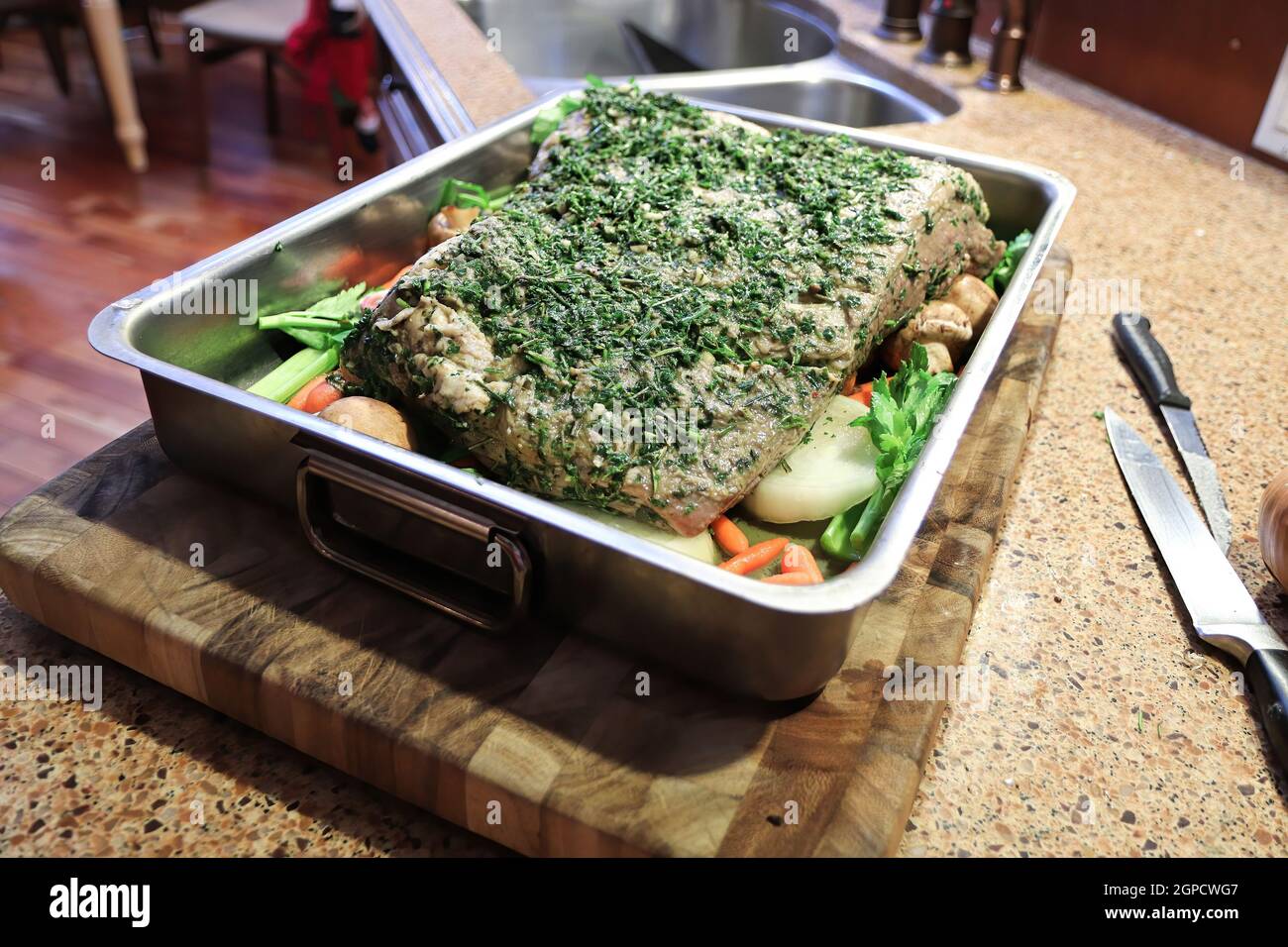 Closeup of a raw brisket in a pan with herbs on top Stock Photo Alamy