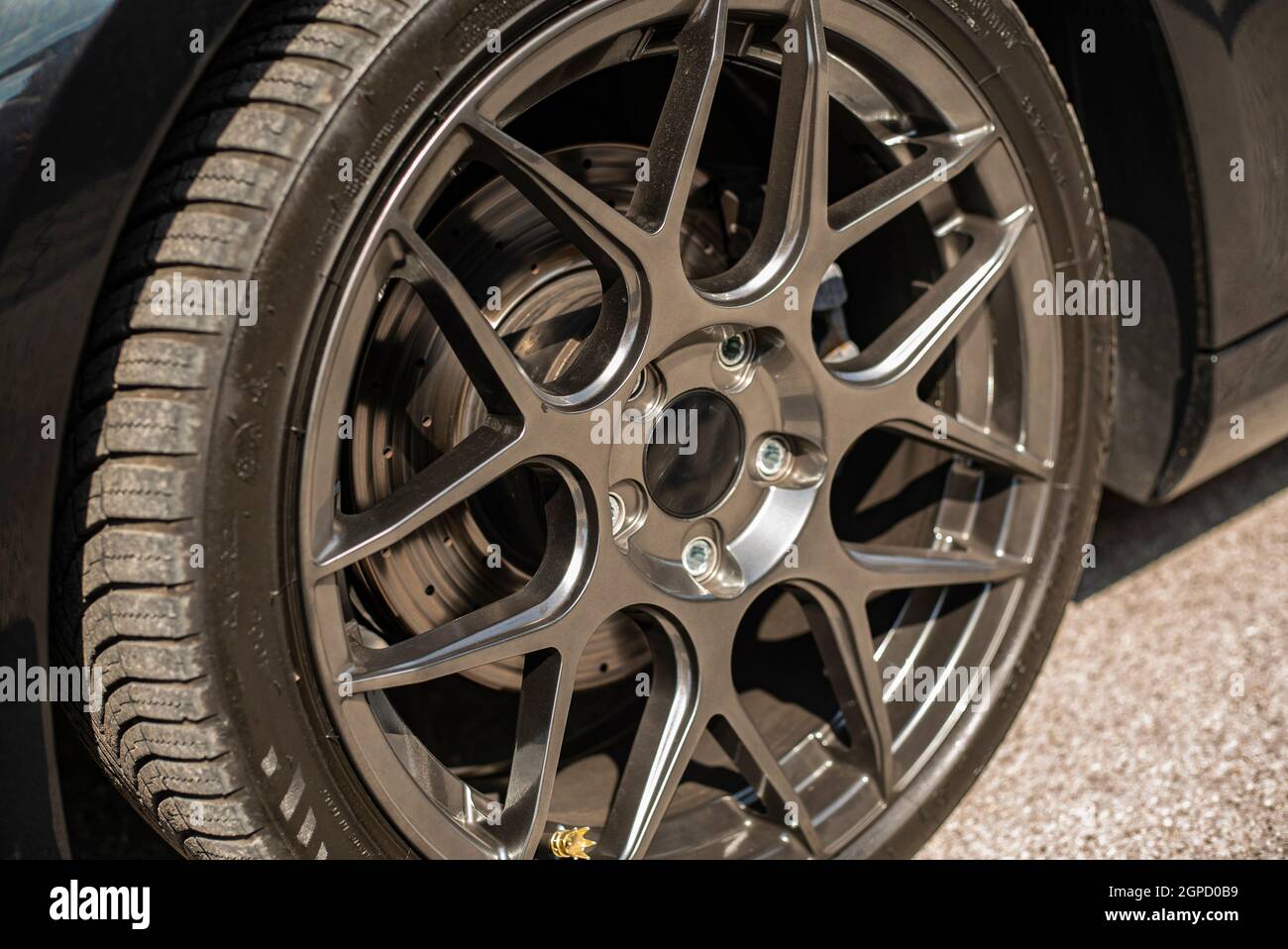 Detail of generic Aftermarket tuning sports rim and wheel Stock Photo