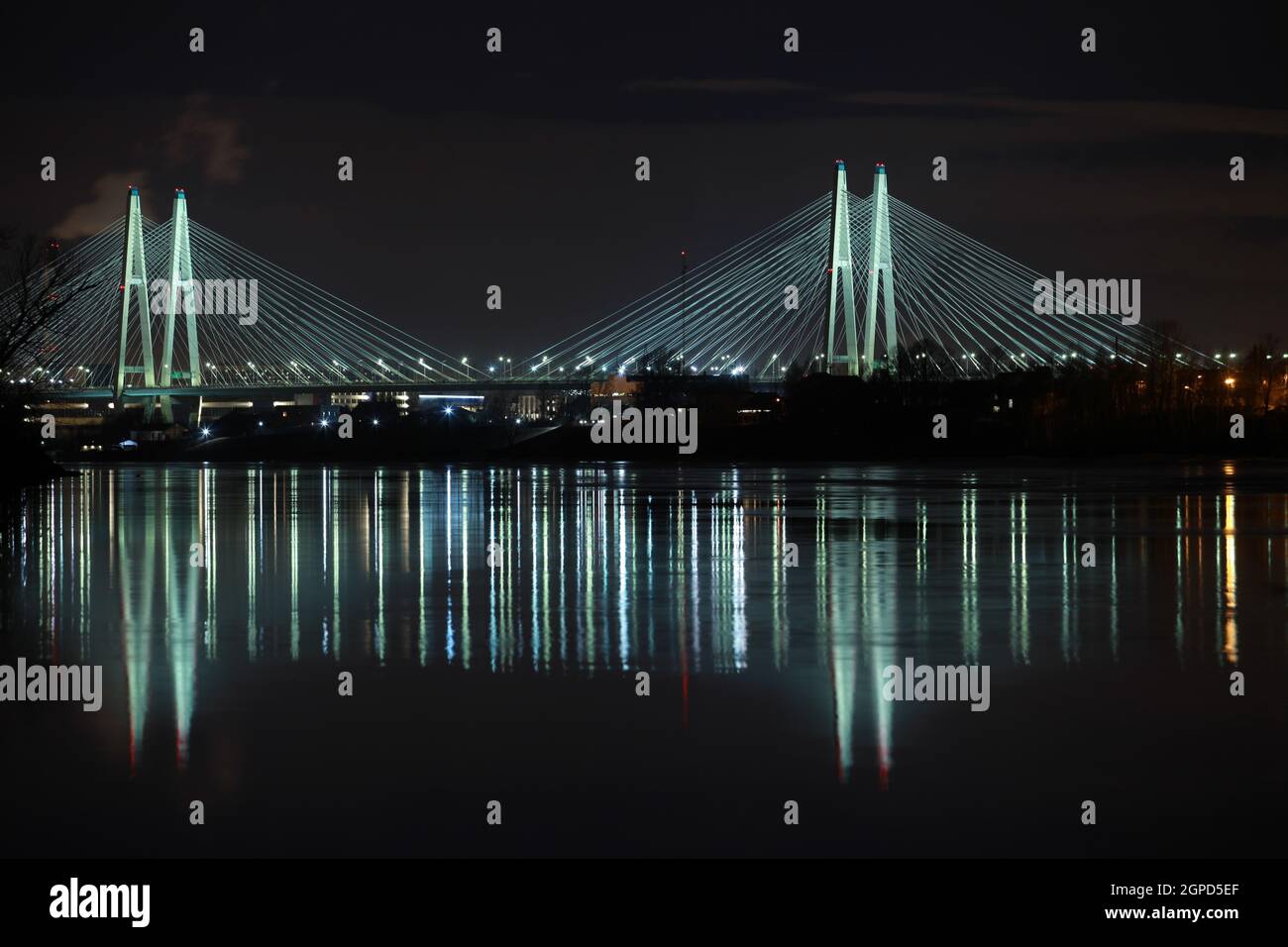 Big cable-stayed bridge of St. Petersburg illuminated at night Stock Photo