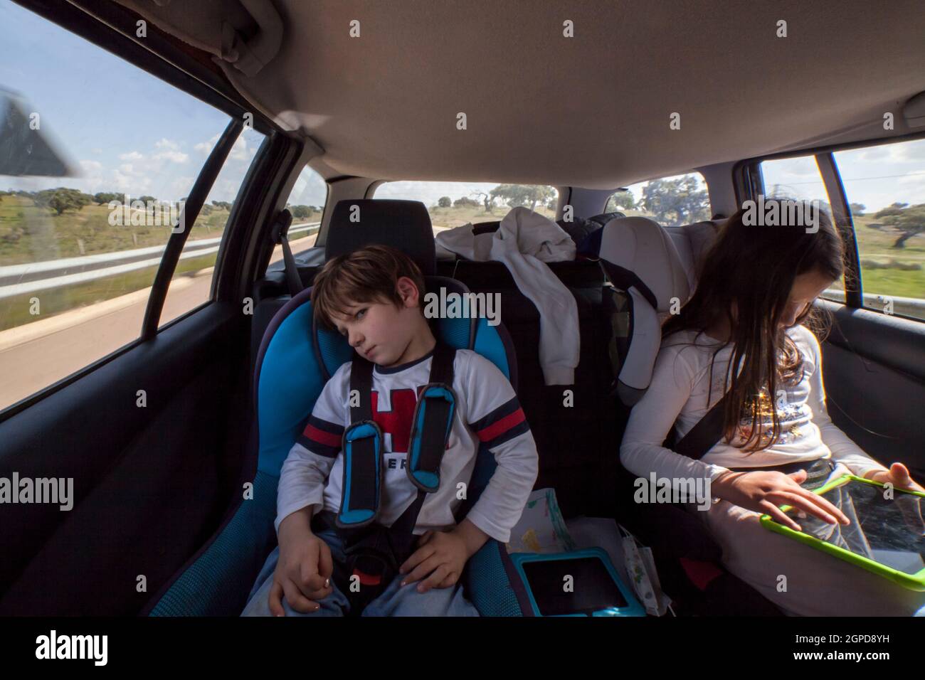 Angry 5 years old boy inside the car. He has been punished by taking away his tablet Stock Photo