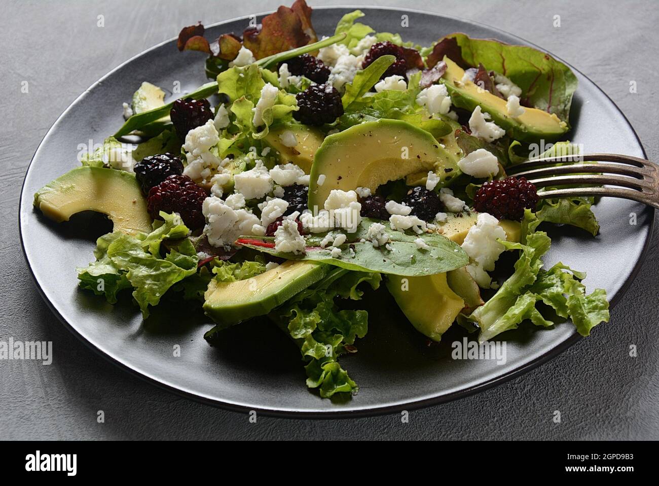 Avocado salad with lettuce, blackberry, blue cheese, olive oil and ...