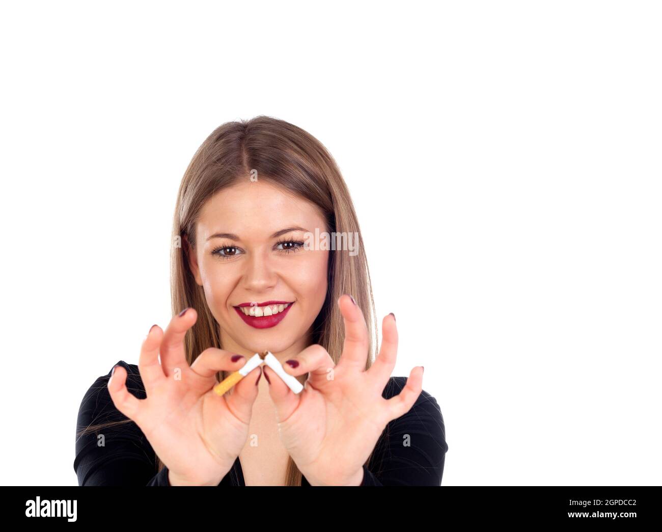 Attractive young woman breaking a cigar isolated on a white background ...