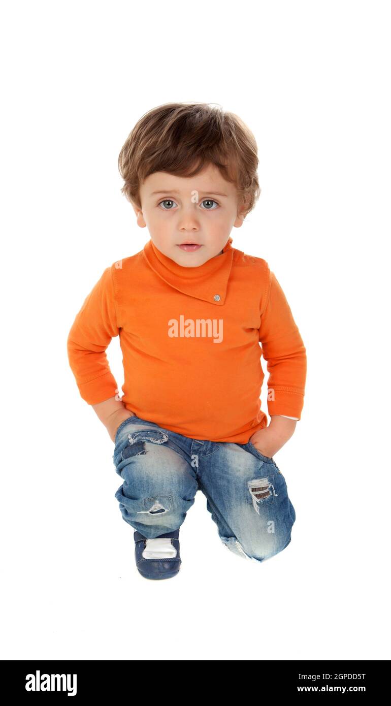 Playful baby on knees with orange jersey isolated on a white background Stock Photo
