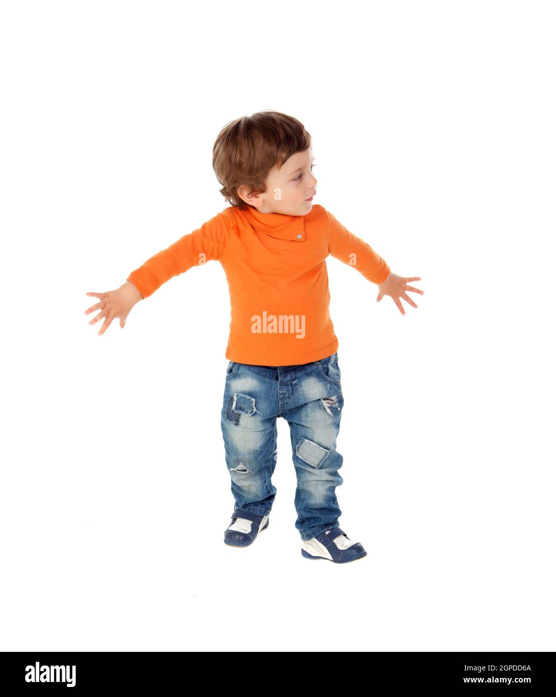Beautiful little child two years old wearing jeans and orange jersey