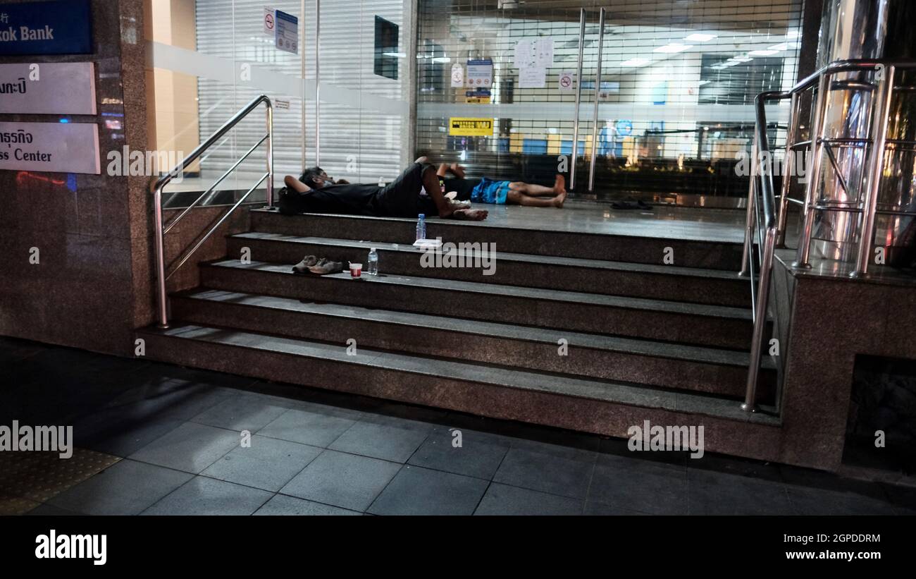 Homeless on Sukhumvit Road between Soi Nana and Soi Asoke on Sunday Night  October 26 2021 Covid 19, Pandemic, lockdown about 7:45 pm Stock Photo