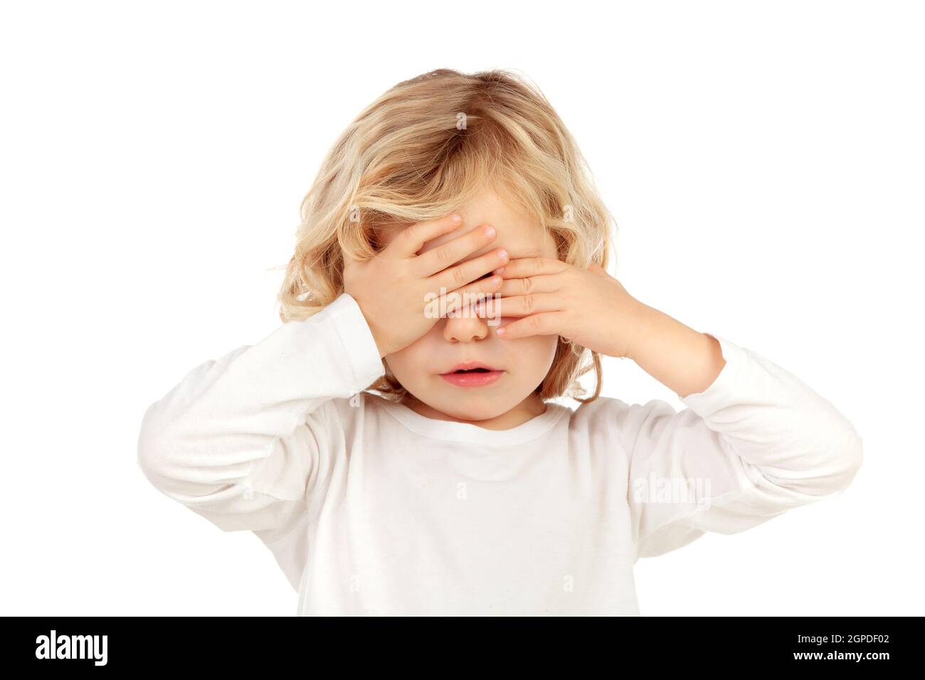 Sad blond child covering the face with his hands isoalted on a white background Stock Photo