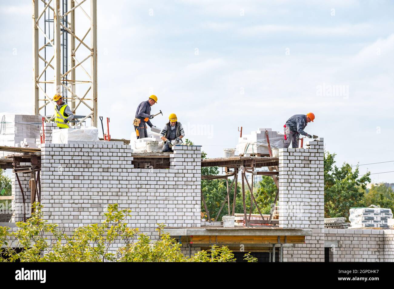 Vilnius, Lithuania - September 28 2021: New buildings or houses under construction with workers at work against cloudy sky Stock Photo