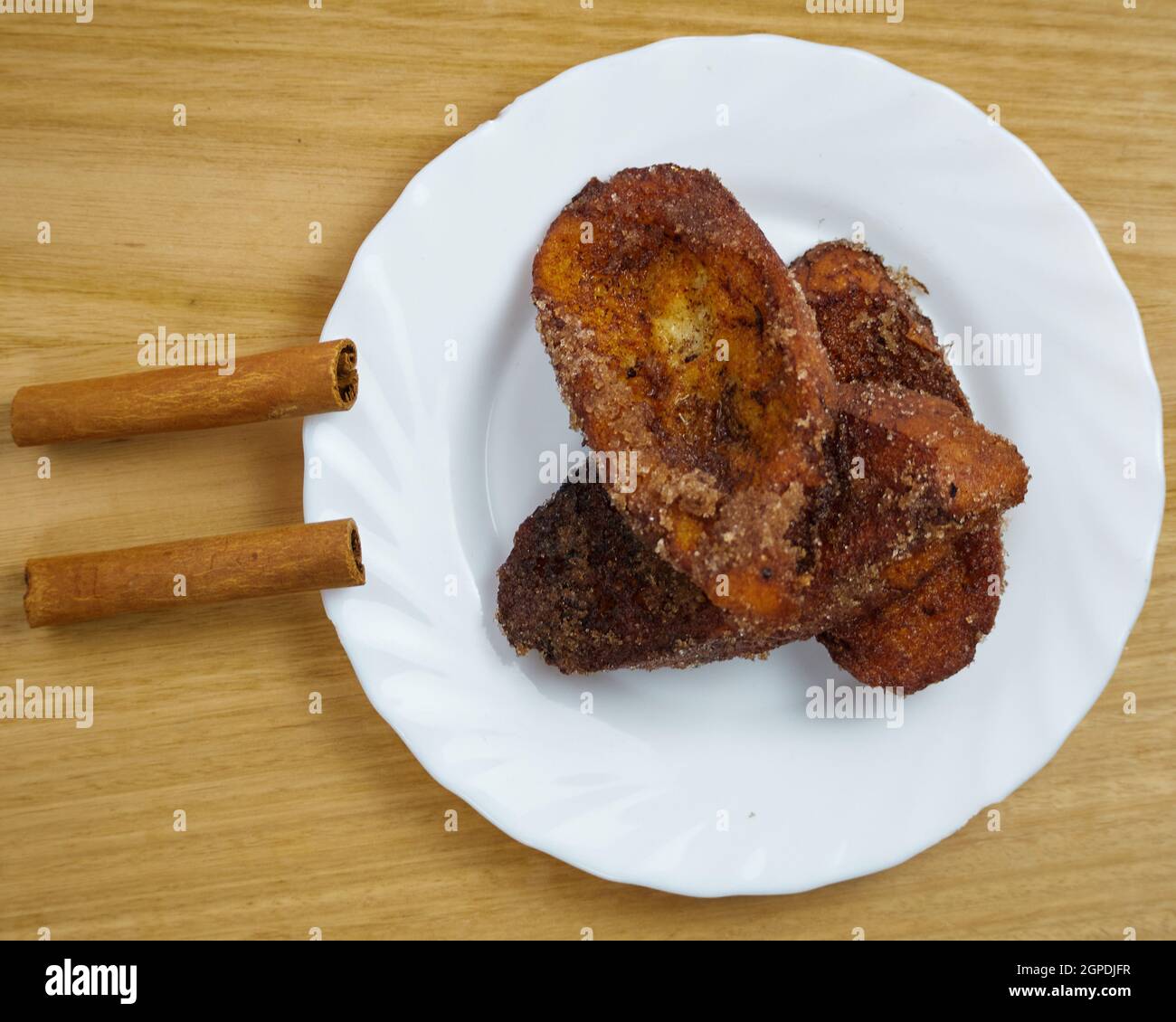 Traditional homemade Spanish Torrijas in a white dish decorated with