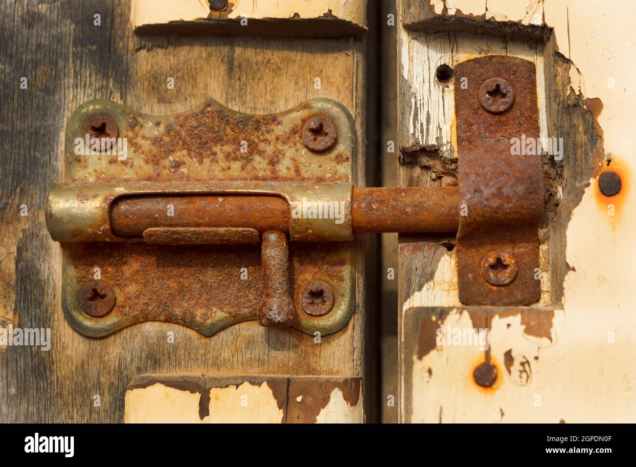Closed rusty on an old wooden door Stock Photo - Alamy