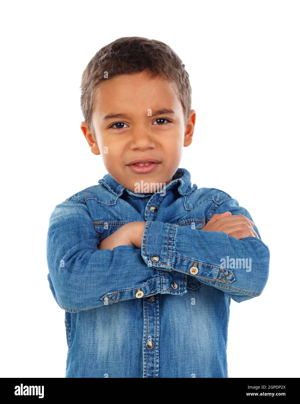 Funny small child with dark hair and black eyes crossing his arms