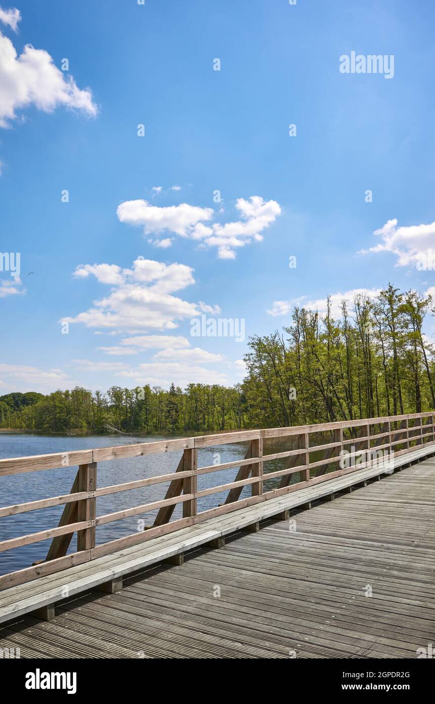 Wooden bridge over Osiek lake, Poland. Stock Photo