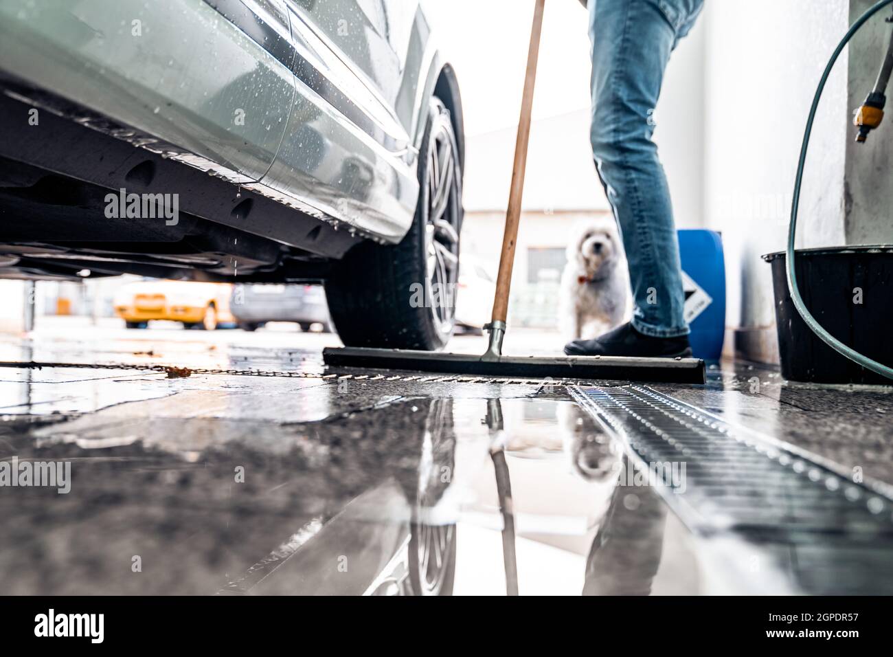 cleaning the floor after washing the car in the dishwasher Stock Photo