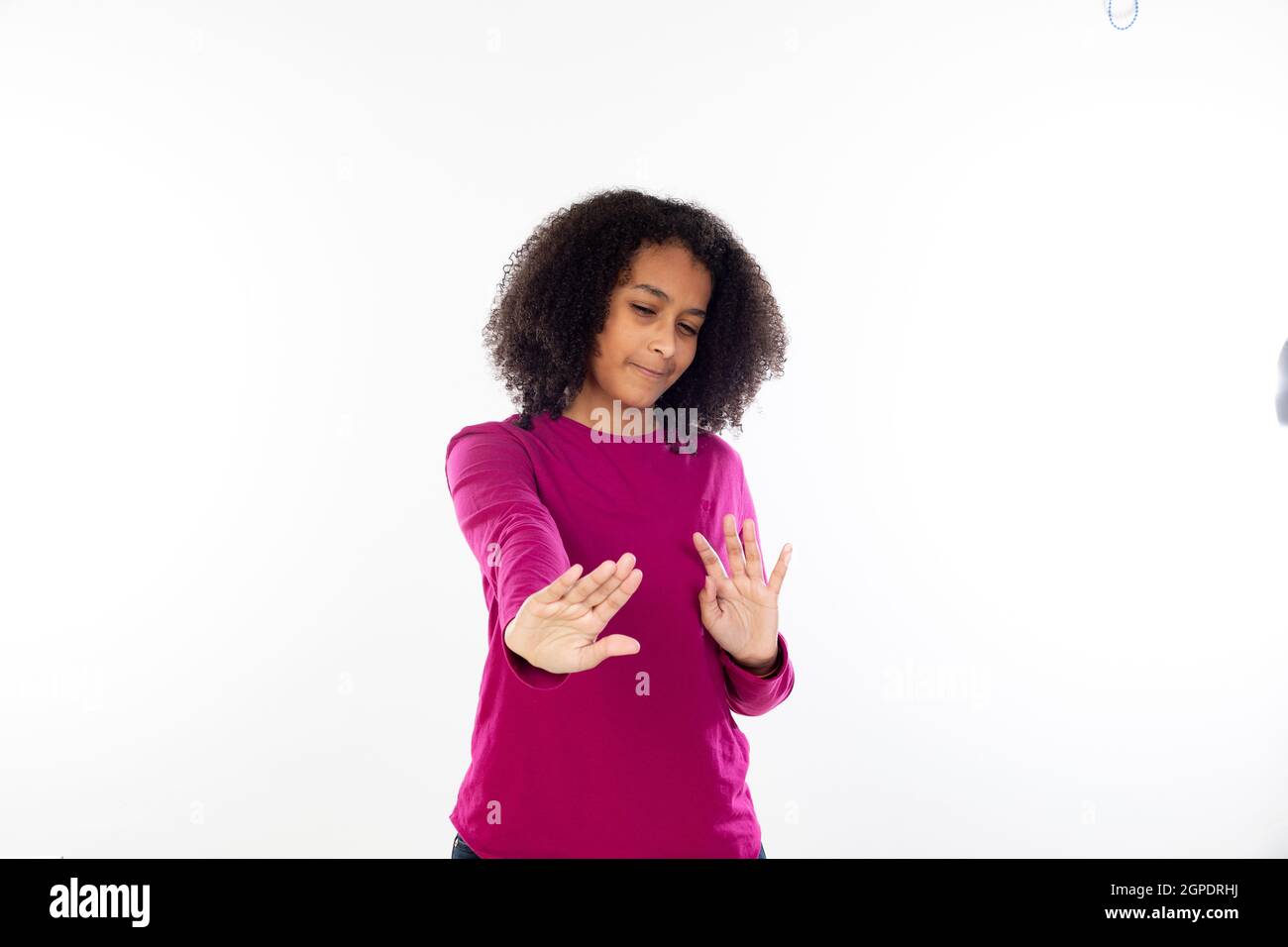 Beautiful teenager girl with pink sweater isolated on a white