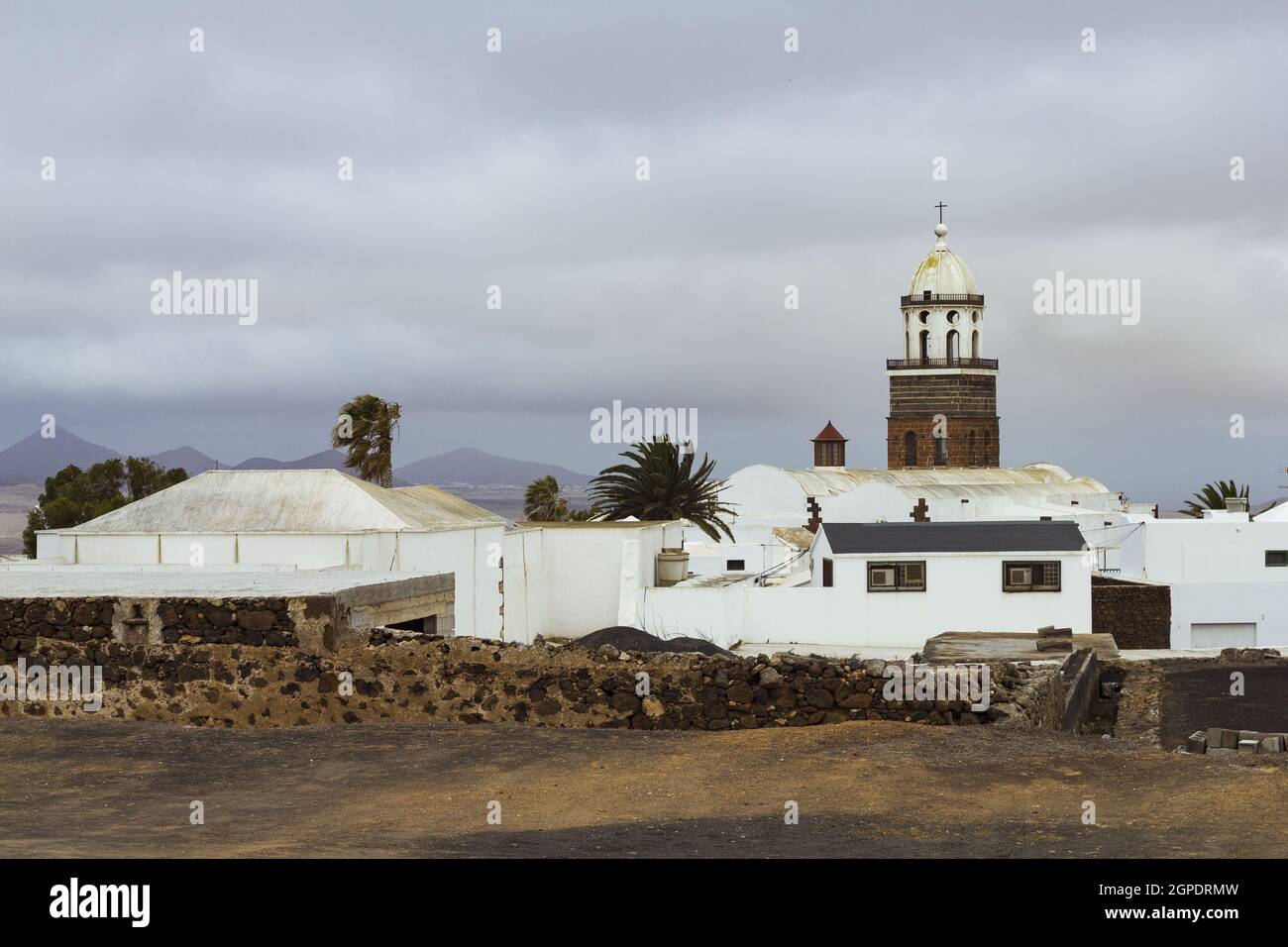 Church in a small village under a cloudy sky Stock Photo - Alamy