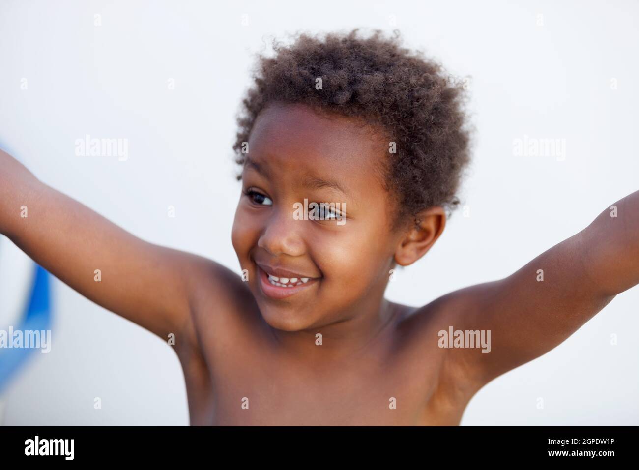 African little kid four years without a shirt on a summer day Stock Photo