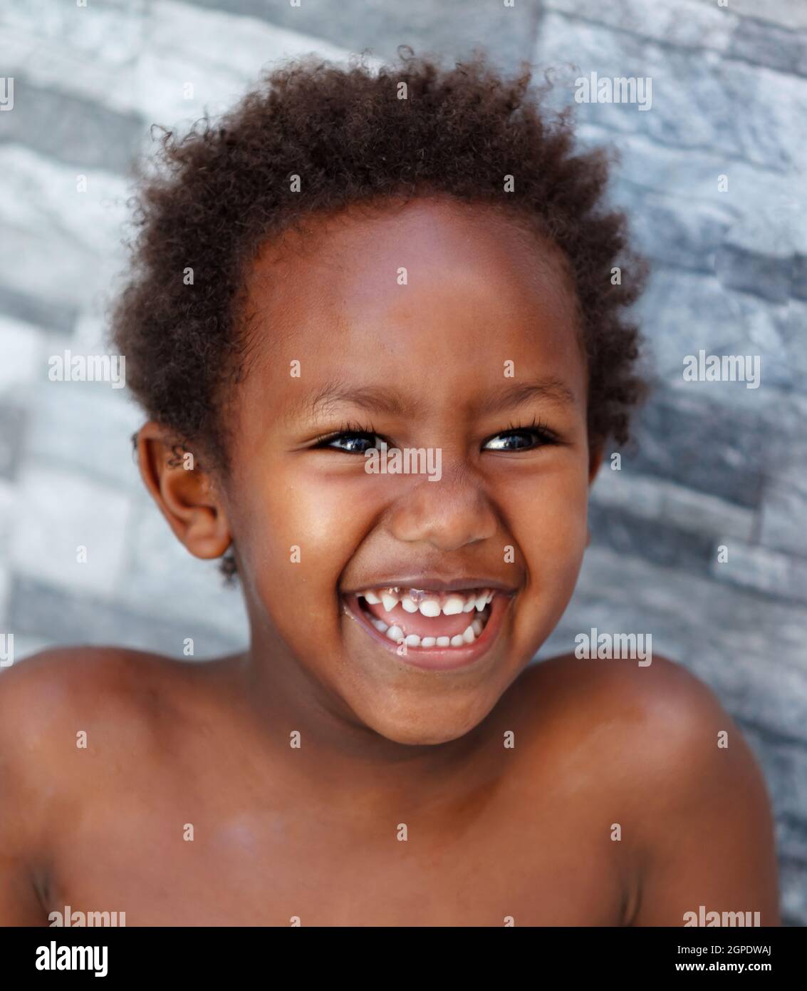 African little kid four years without a shirt on a summer day Stock Photo