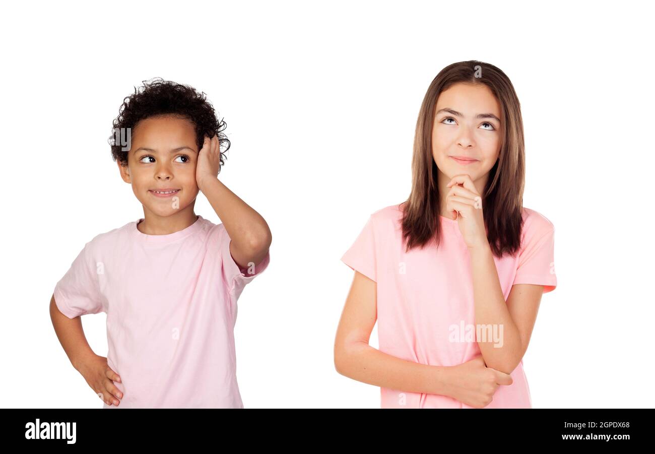 Two pensive children looking up isolated on a white background Stock Photo