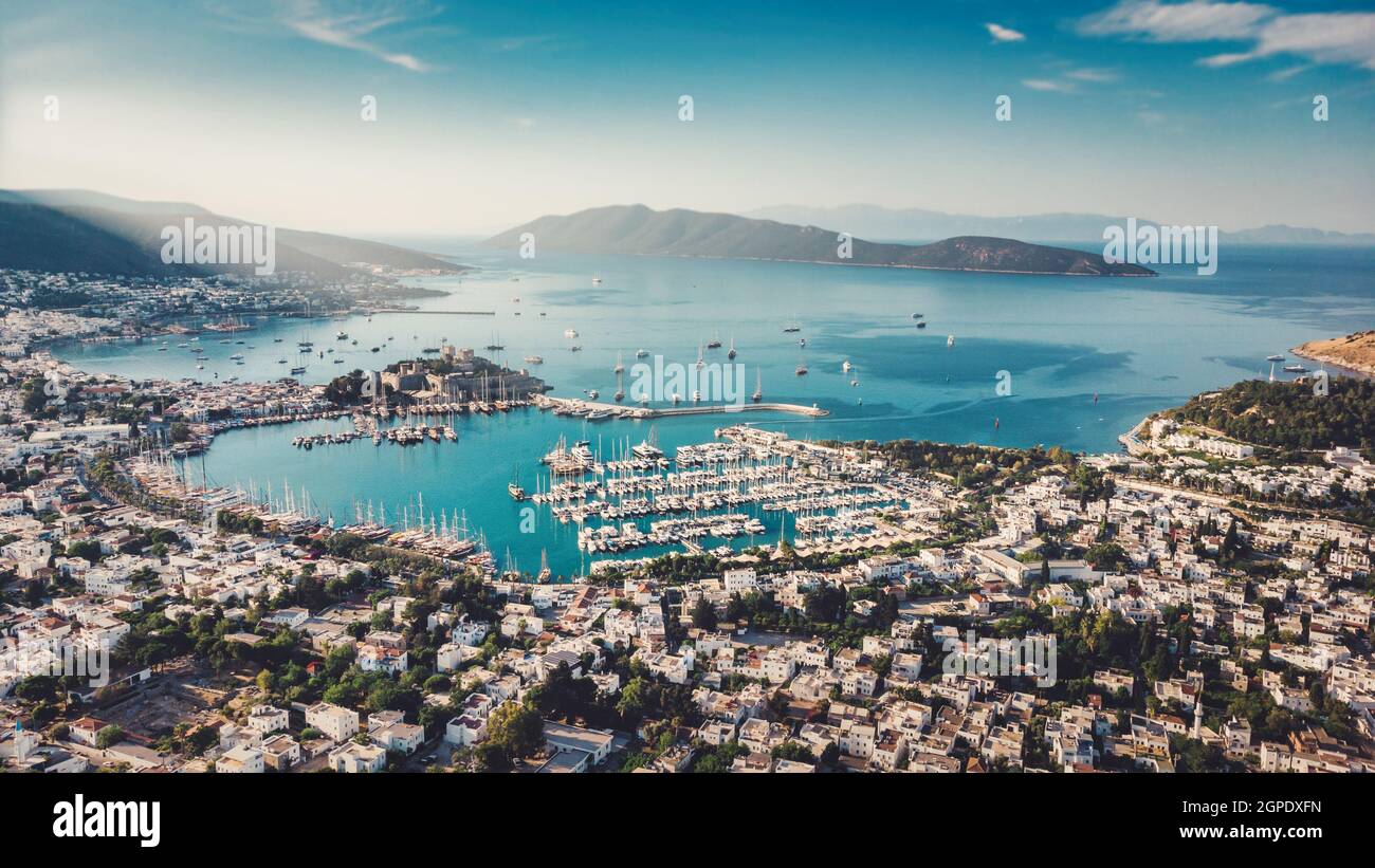 Beautiful European town in greece style on summer sea coast. Natural panoramic landscape view sky, mountains, water, city houses, ships and boats Stock Photo