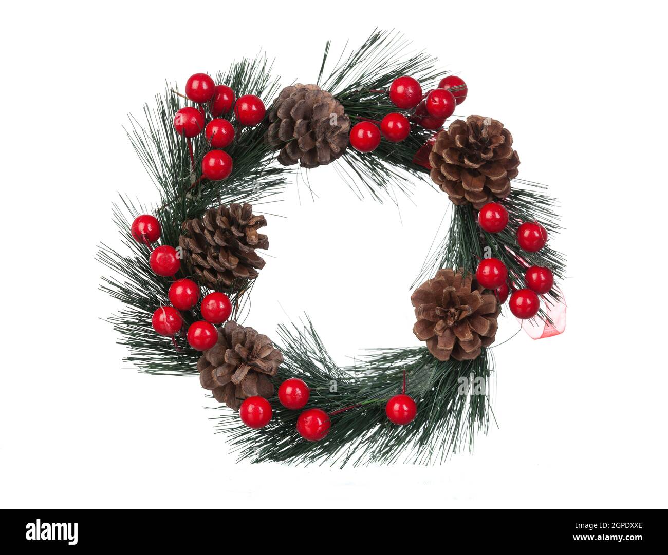 Delicate Christmas wreath with pine cones and red berries isolated on a white background Stock Photo