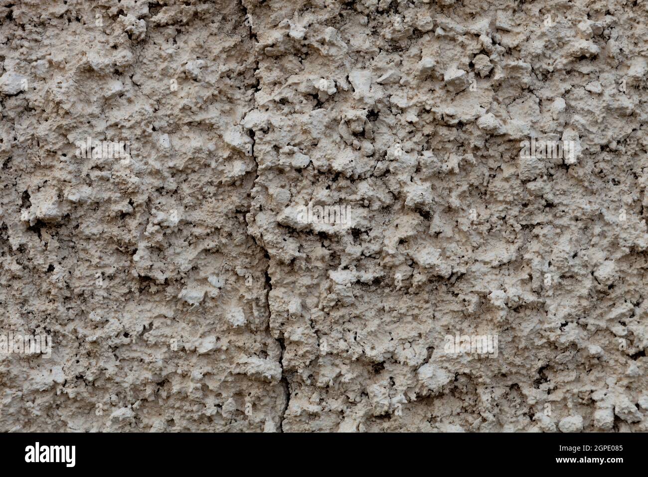 Grey texture of clay in a wall with a crack Stock Photo