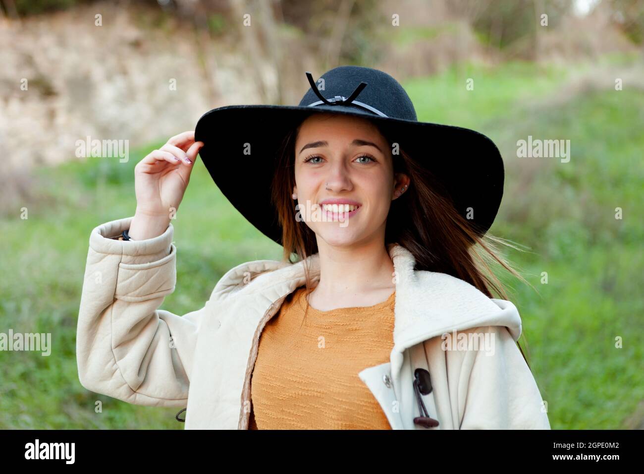 Young trendy hipster woman in black hat and dungaree Stock Photo