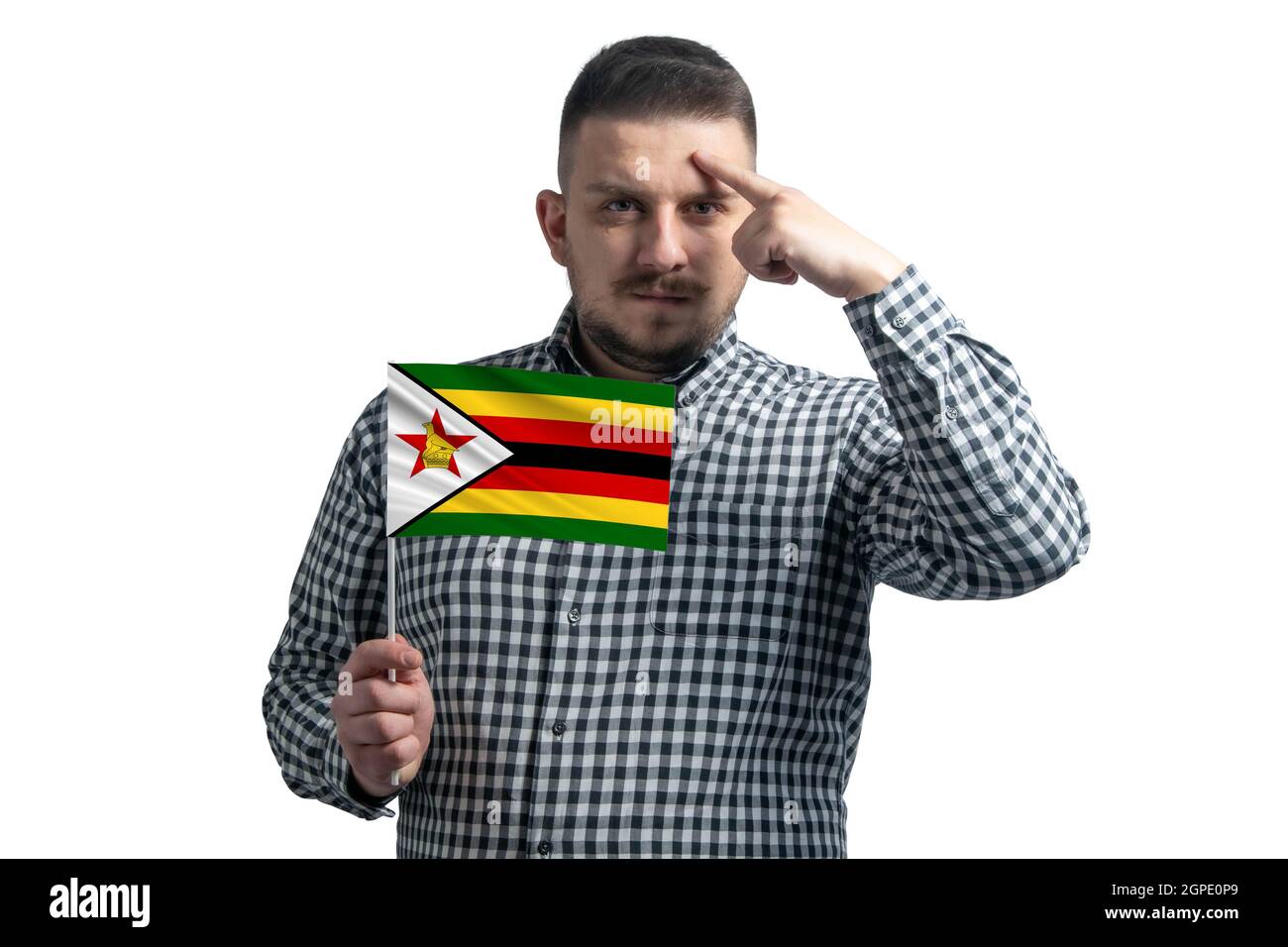 White guy holding a flag of Zimbabwe and a finger touches the temple on