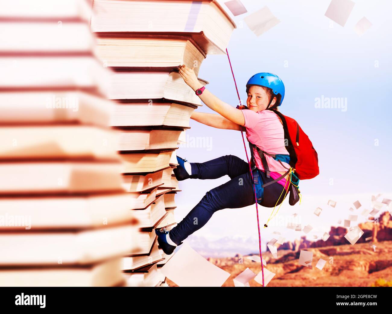 Girl rock climb on the mountain of knowledge books Stock Photo