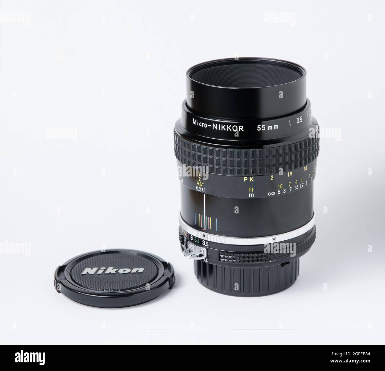 Nikon Micro-Nikkor 55mm 1:3.5 classic macro lens on white background, side  view with lens cap Stock Photo - Alamy
