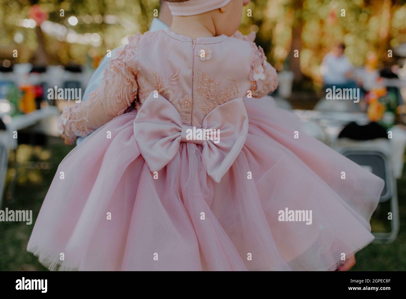 Closeup shot of a baby girl in a pink dress Stock Photo - Alamy