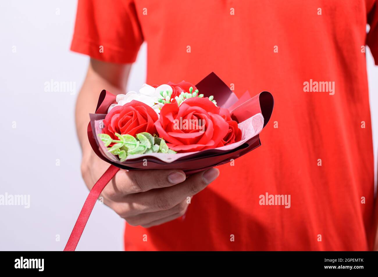 Men hold a bouquet of roses on valentine's day Stock Photo - Alamy