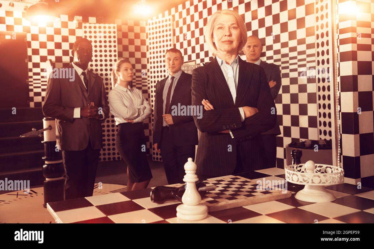 Toned image of confident business woman on background with team Stock Photo