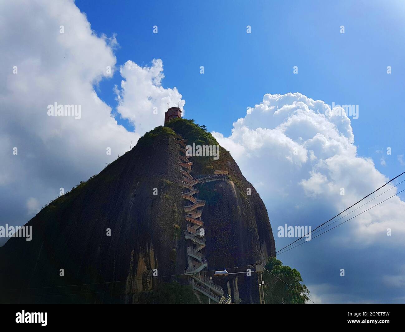 Closeup shot of El Penon de Guatape under a blue cloudy sky in Colombia Stock Photo