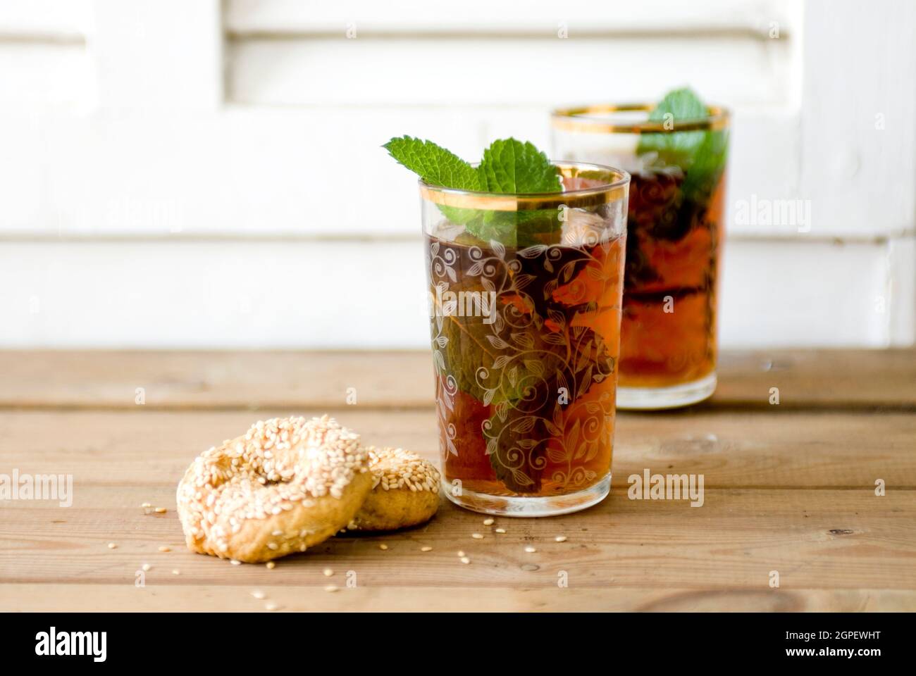 Glass of mint tea, close-up with savoury biscuits Stock Photo