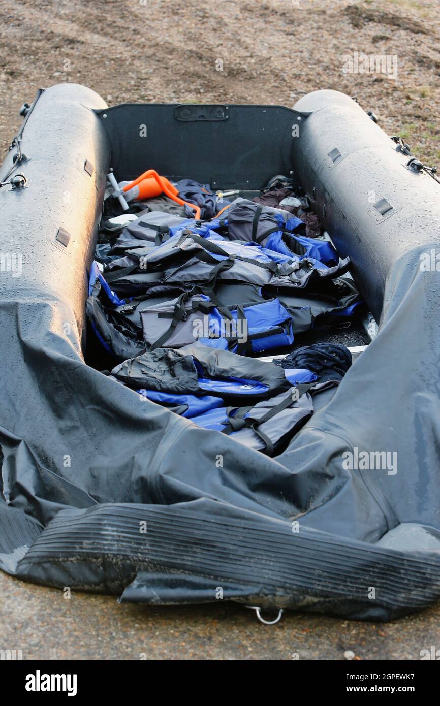 England, Kent, Dungeness, Discarded rubber dingy with lifejackets used by migrants who had crossed the channel. Stock Photo